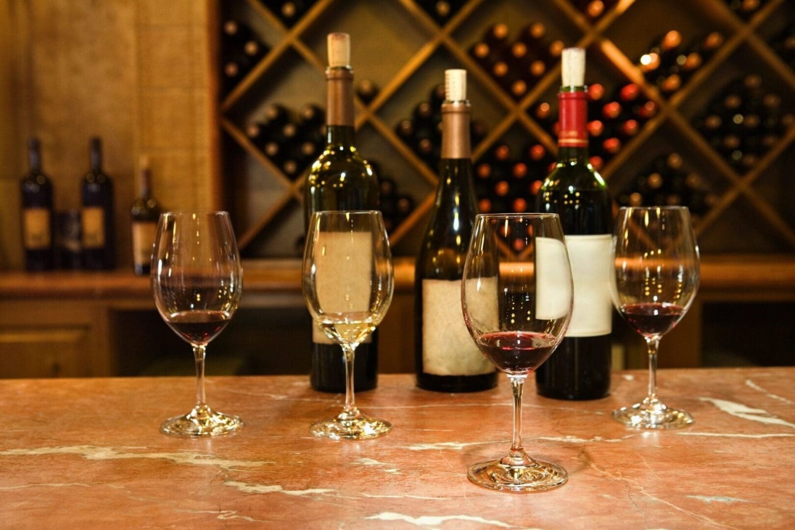 A table with wine glasses and bottles of wine.