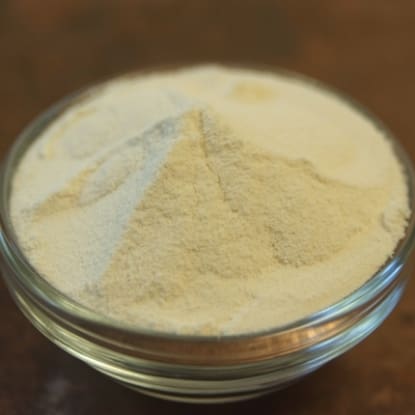 A glass bowl of white powder on top of a table.