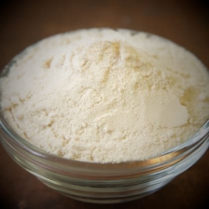 A bowl of white powder on top of a table.