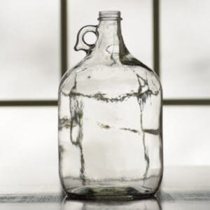 Empty glass jug with handle.