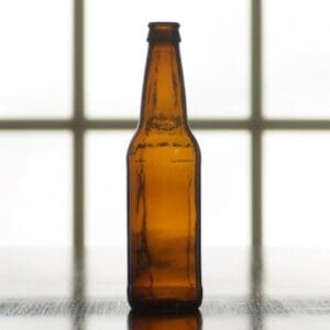 Empty brown glass beer bottle.