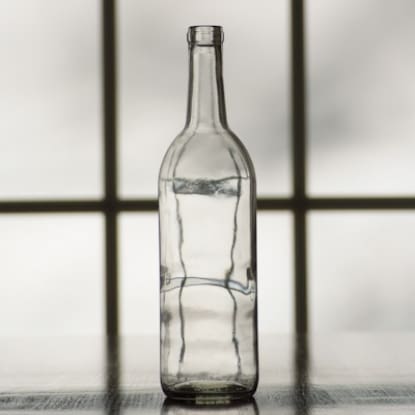 Empty glass wine bottle on a table.