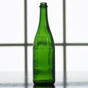 Empty green glass bottle on table.