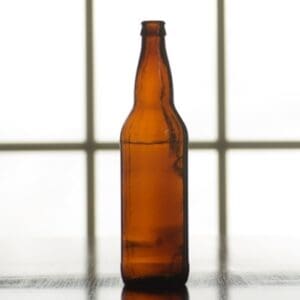 Empty brown glass beer bottle.