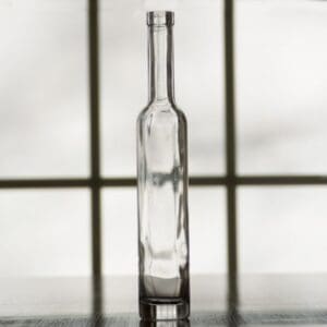 Empty glass bottle on a table.