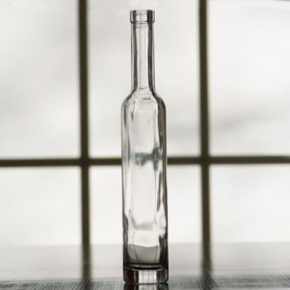 Empty glass bottle on a table.