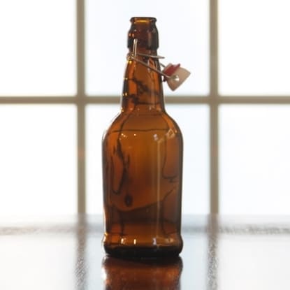 Brown glass bottle with swing top.