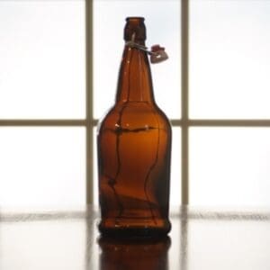 Brown glass bottle with wire closure.