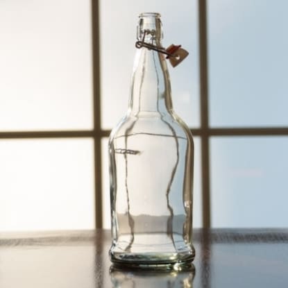 Clear glass bottle with swing top