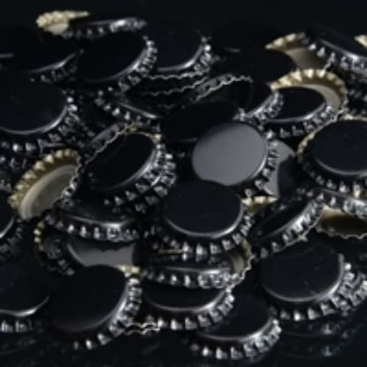 Pile of black bottle caps with silver rims.