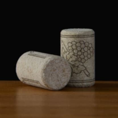 Two wine corks with grape design.