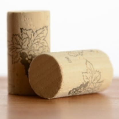 Two wine corks with grape designs.