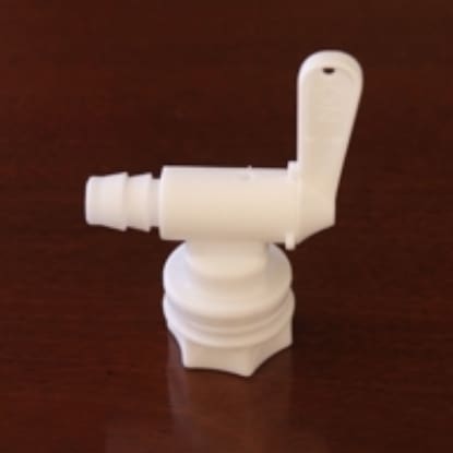 White plastic bottle spout with lever.