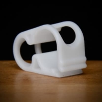 White plastic cable clamp for wires.