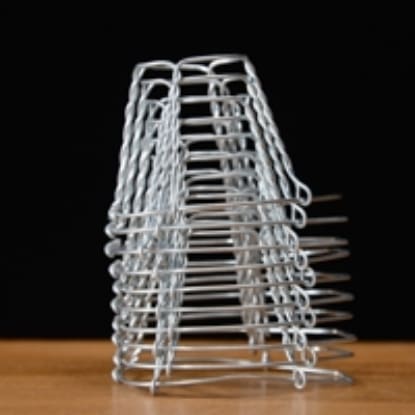 Stack of wire bottle cages on table.