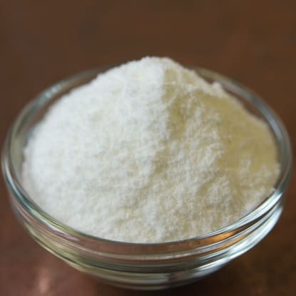 A bowl of white powder on top of a table.