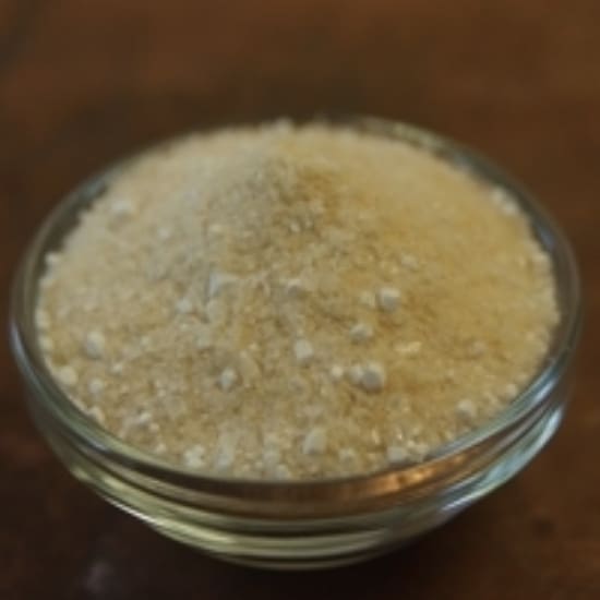 A glass bowl of rice on top of a table.