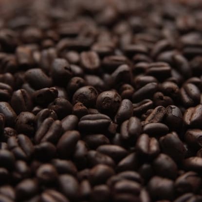 A close up of coffee beans on the ground