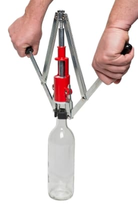 Hands using a bottle capper on a bottle.