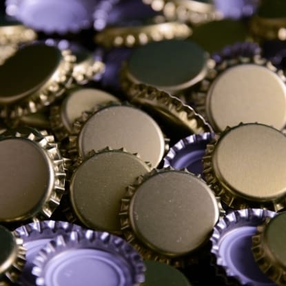 Close-up of golden bottle caps.