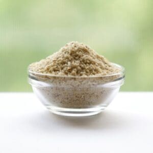 A bowl of brown sand on top of a table.