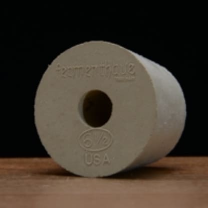 White rubber stopper with hole and size.